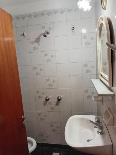 a bathroom with a sink and a toilet and a mirror at Hotel guido palace in Buenos Aires