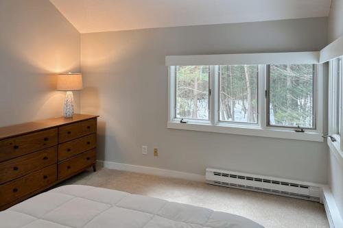 a bedroom with a bed and a dresser and a window at Butternut Hill D5 in Waitsfield