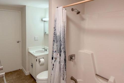 a white bathroom with a toilet and a sink at Butternut Hill D5 in Waitsfield