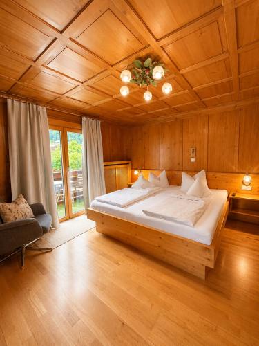 a bedroom with a large bed with a wooden ceiling at Faneskla Apartments in Silbertal