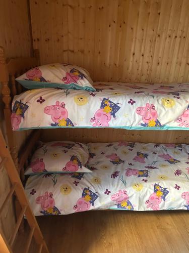 two bunk beds with hello kitty sheets and pillows at LEMAFIOlY in Cemboing