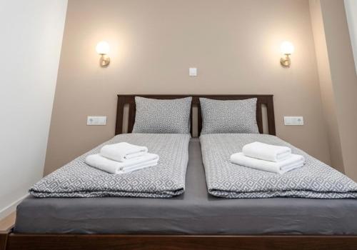 a bedroom with two beds with towels on them at Danilo Room 1 in Pula