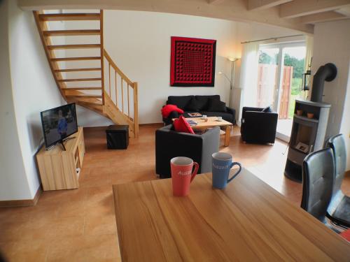 a living room with a table and a couch at Auszeit - Nordhorn in Nordhorn