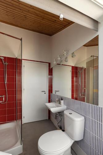 a bathroom with a toilet and a sink and a shower at Flat 23 in Bombarral
