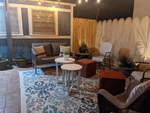 a patio with chairs and a couch and a table at Backyard Bungalow private guest house in Riverside