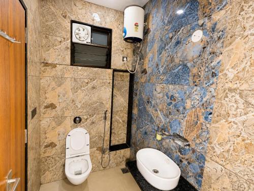 a bathroom with two toilets and a sink at Hotel Heera Palace in Khātu