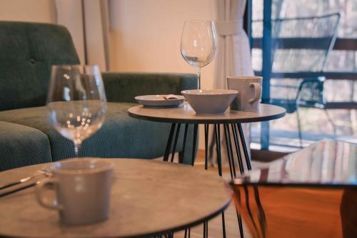 two tables with wine glasses and bowls on them at rinne 北軽井沢 Forest3 in Tsumagoi