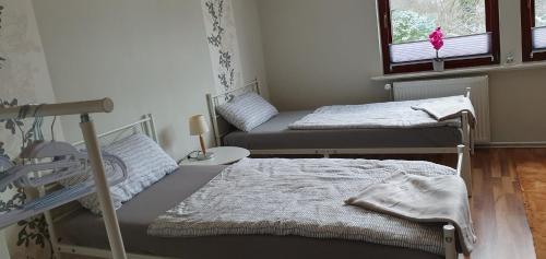 a room with two beds and a window at Ferienwohnung in Walsrode