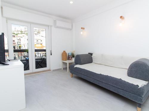 a living room with a couch and a television at Old Town Spot Apartment by Stay ici in Albufeira