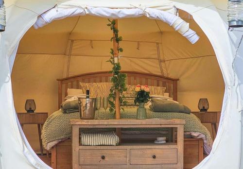 a bedroom with a bed in a tent at Roden Retreat in Aston