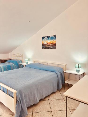 a bedroom with two beds and two tables at Grandmother's Attic in Furore