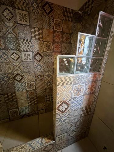 a room with a wall with different tiles on it at HSR Termas in Termas de Río Hondo