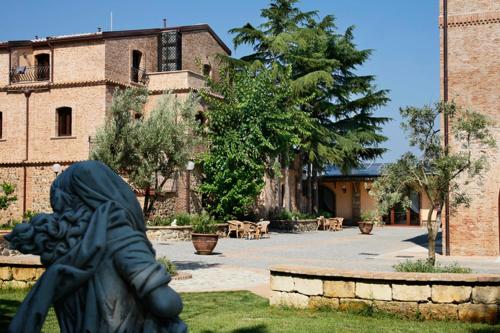 a statue of a woman standing in front of a building at Relais Il Mulino in Corigliano Calabro