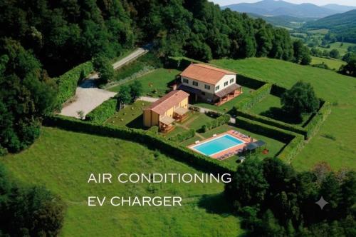 an aerial view of a house with a swimming pool at Agriturismo La Burraia - near San Gimignano, Air conditioning, STARLINK, EV wallbox in Gambassi Terme