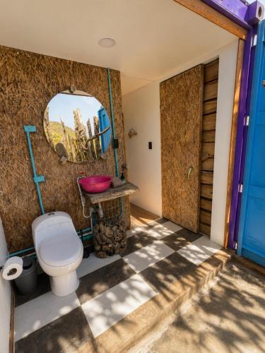 a bathroom with a toilet and a mirror at Mojarra Beach-Wind Room- Santa Veronica in Salina de Rey
