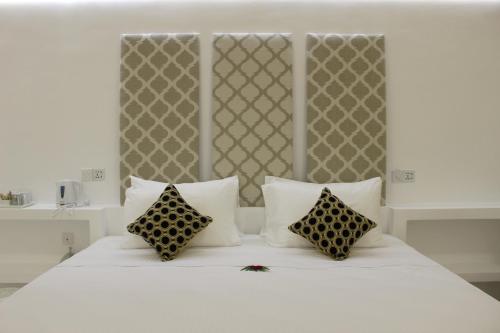 a white bed with two pillows on top of it at Heaven By O in Unawatuna