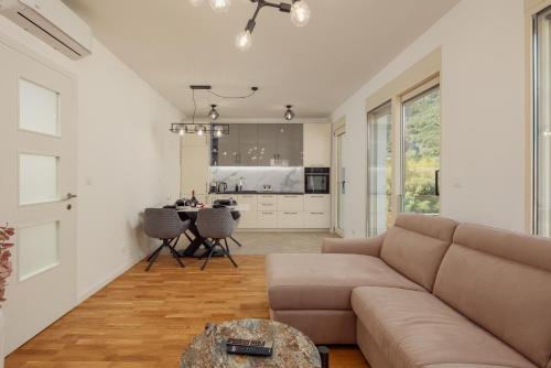 a living room with a couch and a table at Vujicic Premium Suite in Tivat