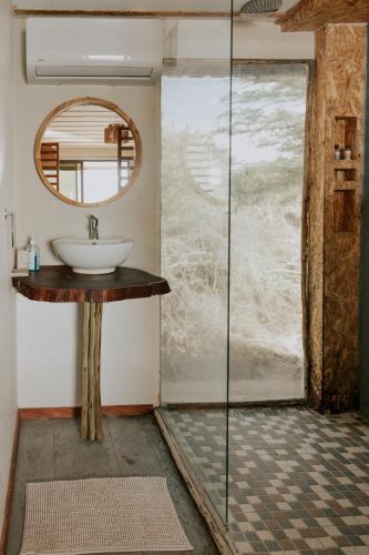 a bathroom with a sink and a mirror at Muchenje River Lodge in Katima Mulilo
