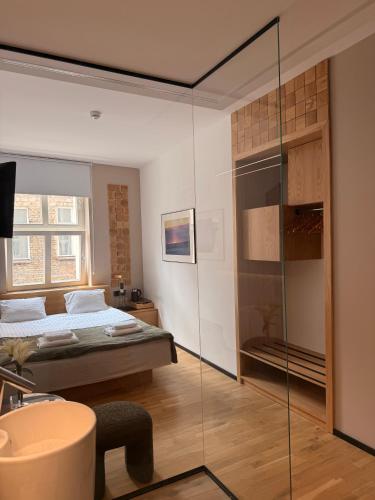 a bedroom with a bed and a glass wall at Kamea in Poznań