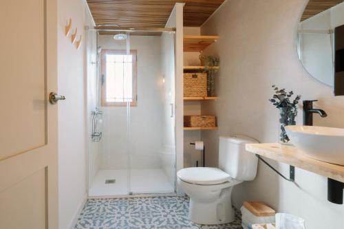 a bathroom with a shower and a toilet and a sink at Masia CHOPO in L'Aldea
