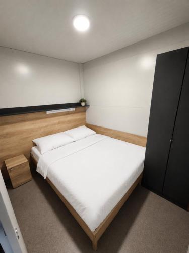 a small bedroom with a bed and a cabinet at Rilux Mobile Home "Camping Pirovac" in Pirovac