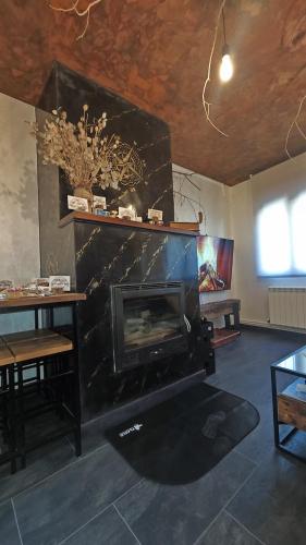 a living room with a fireplace and a table at Paraíso Desconocido 1. Pura Magia in Cardaño de Abajo