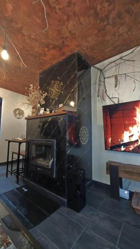 a living room with a fireplace and a table at Paraíso Desconocido 1. Pura Magia in Cardaño de Abajo