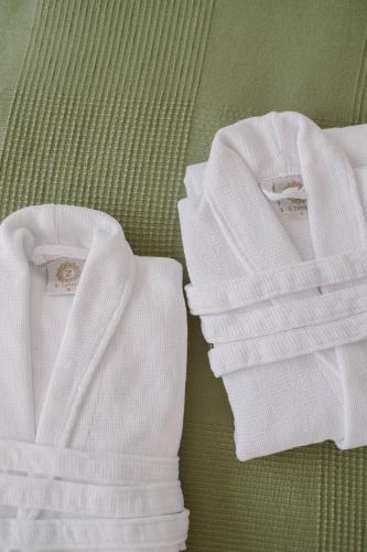 two white towels sitting on top of a green table at Well M cottage in Velem