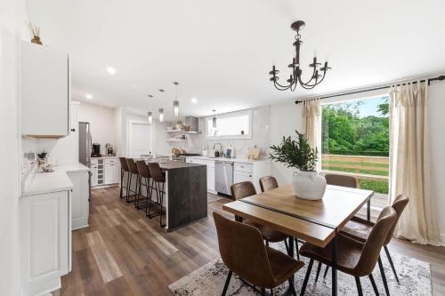 a kitchen and dining room with a table and chairs at Cozy Haven in Three Oaks