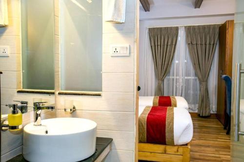 a bathroom with a sink and a bed at Beautiful Kathmandu Swimming pool Hotel in Kathmandu