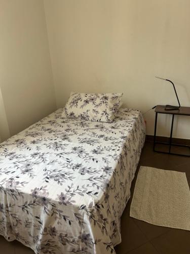 a bed in a room with a pillow and a table at Pasa da sí in Alba