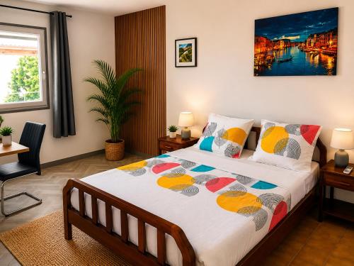 a bedroom with a large bed in a room at Le JUJUBIER in Le Robert