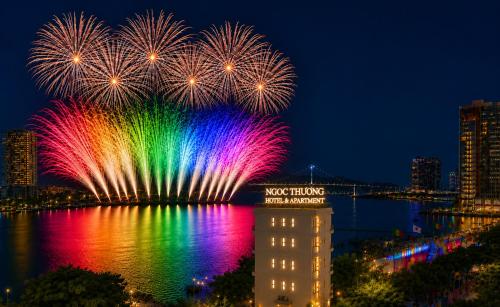 a firework display over the water with a city at Ngoc Thuong Hotel & Apartment- Han River View in Danang