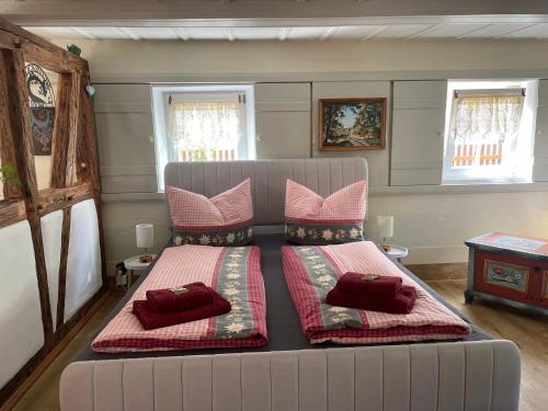 a bed with pillows on it in a room at FEWO Blockstube Frieda in Kottmar