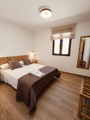 a bedroom with a large bed in a room at Casa Rural Las Alcusa in Cubla