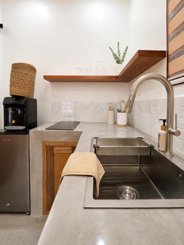 a kitchen with a sink and a counter top at White Palm Villa 1 in General Luna