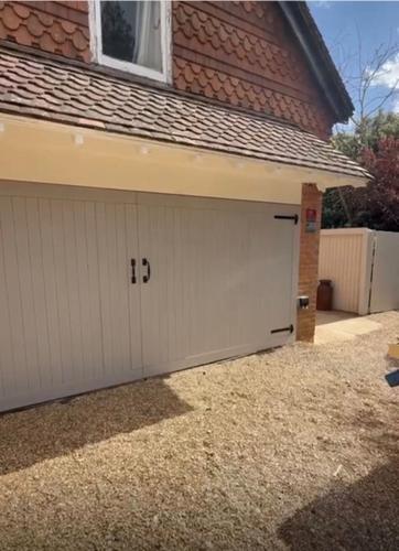 a garage door with the letter b on it at 1 Bridge Rd in Cranleigh