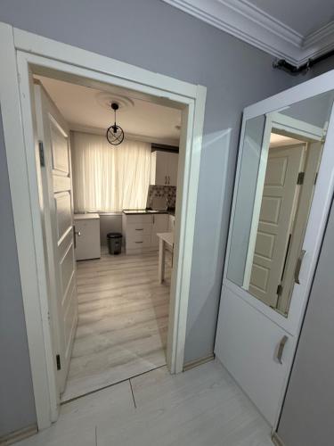 a hallway with a door and a mirror in a room at Nokta Suite in Trabzon