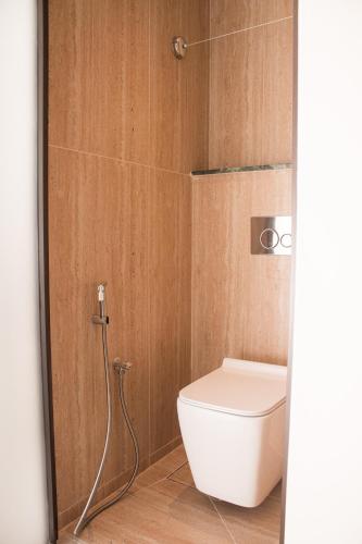 a bathroom with a toilet and a shower at Souq Beach Hotel فندق سوق الشاطئ in Salalah