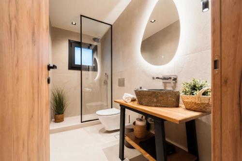 a bathroom with a sink and a toilet at Ammosphere in Nea Peramos