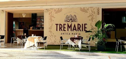 a restaurant with tables and chairs in front of it at Hotel Dante in Cattolica