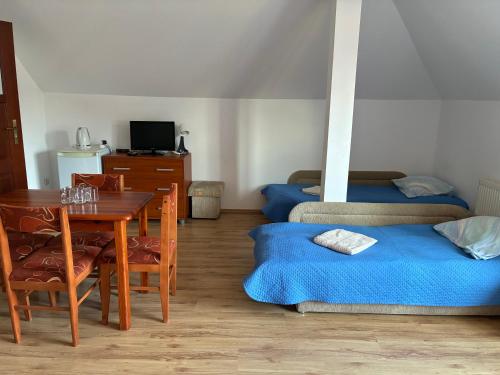 a room with a table and chairs and a dining room at Żółta Chata in Władysławowo