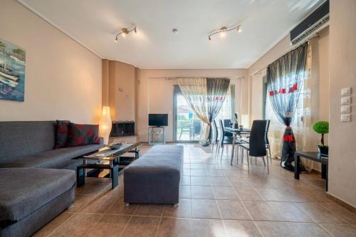 a living room with a couch and a table at Villa Violetta in Nea Anchialos