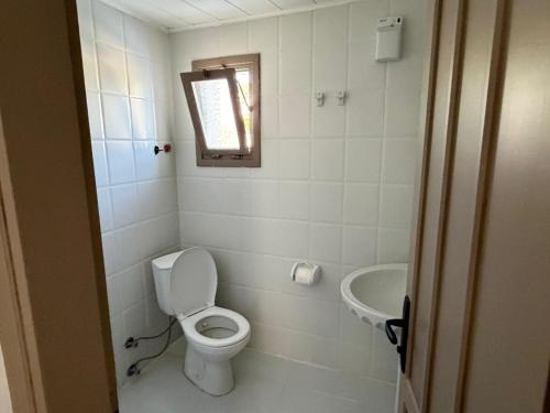 a small bathroom with a toilet and a sink at CİELO Otel in Bodrum City