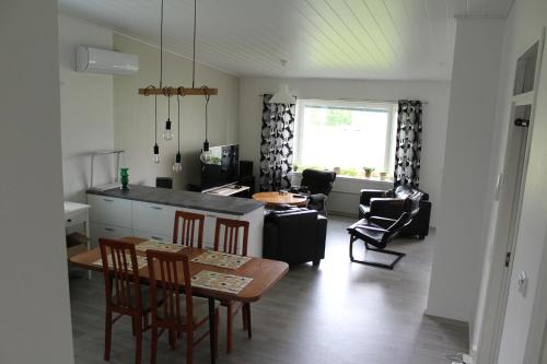 a kitchen and living room with a table and chairs at Pikkurinki 27 As 2, Härmä in Härmä