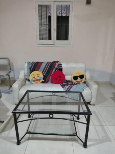 a living room with a couch with a glass coffee table at Casa chalet cerca nodo y estadio in Santiago del Estero