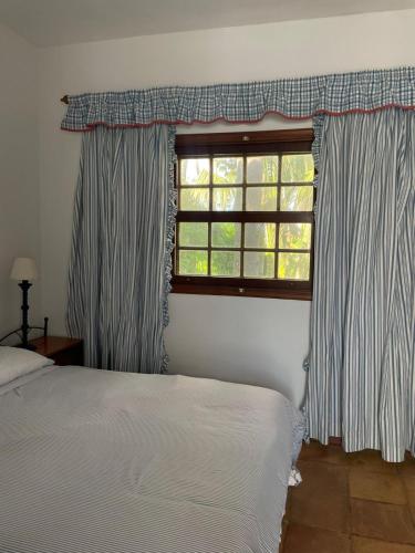 a bedroom with a bed and a window at La Vereda - Rural getaway, pool, golf & hiking lovers in Tacoronte