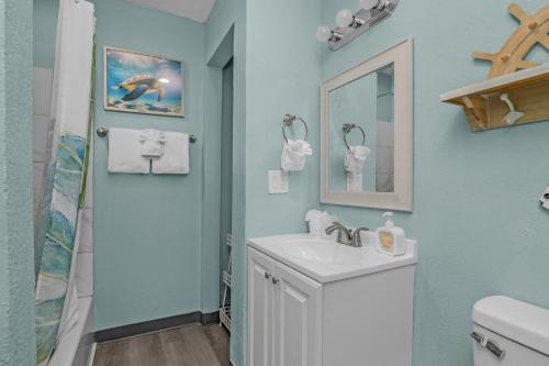 a bathroom with a white sink and a shower at Latitude 26 Waterfront Boutique Resort - Fort Myers Beach in Fort Myers Beach