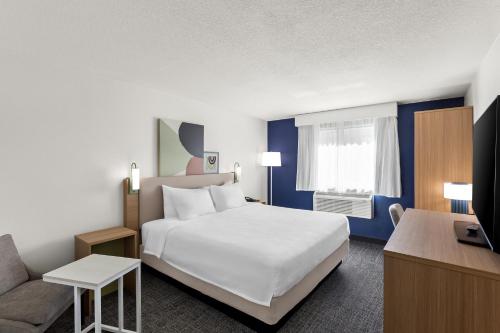 a hotel room with a bed and a couch at Spark By Hilton Beckley in Beckley