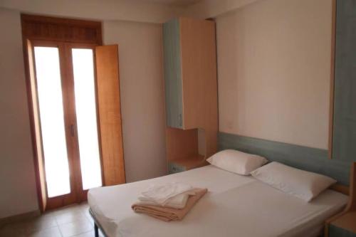 a bedroom with a bed with two towels on it at Vieste Residence Gallo Con Piscina in Vieste